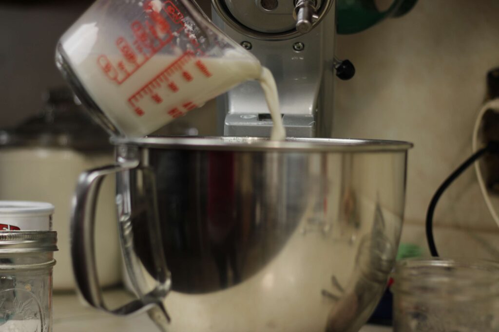 buttermilk substitute being added to mixer bowl