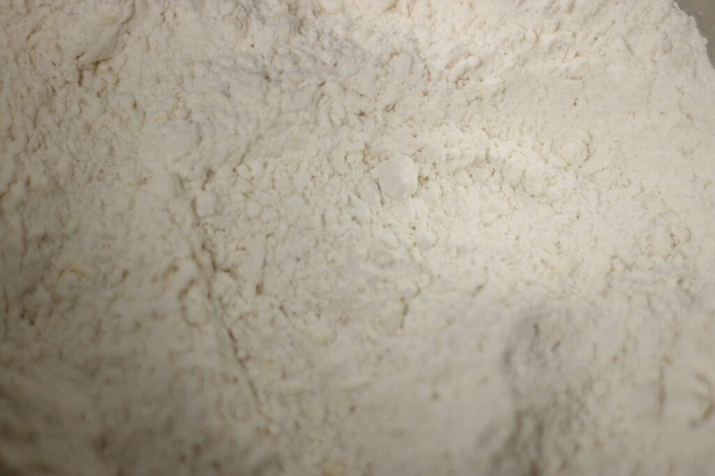 Close up flour texture after cold shredded butter has been added.