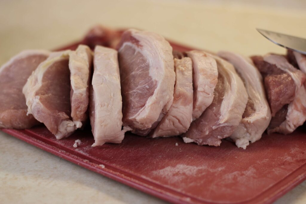 raw pork loin cut into pork chops