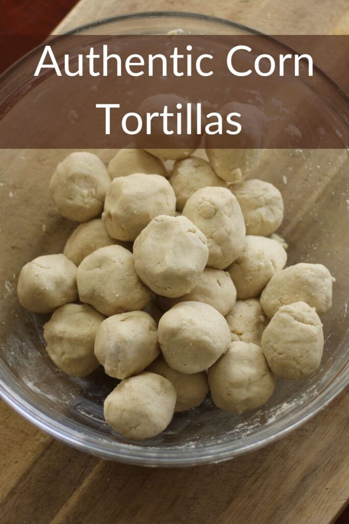 golf size balls of masa dough in glass bowl to make homemade corn tortillas