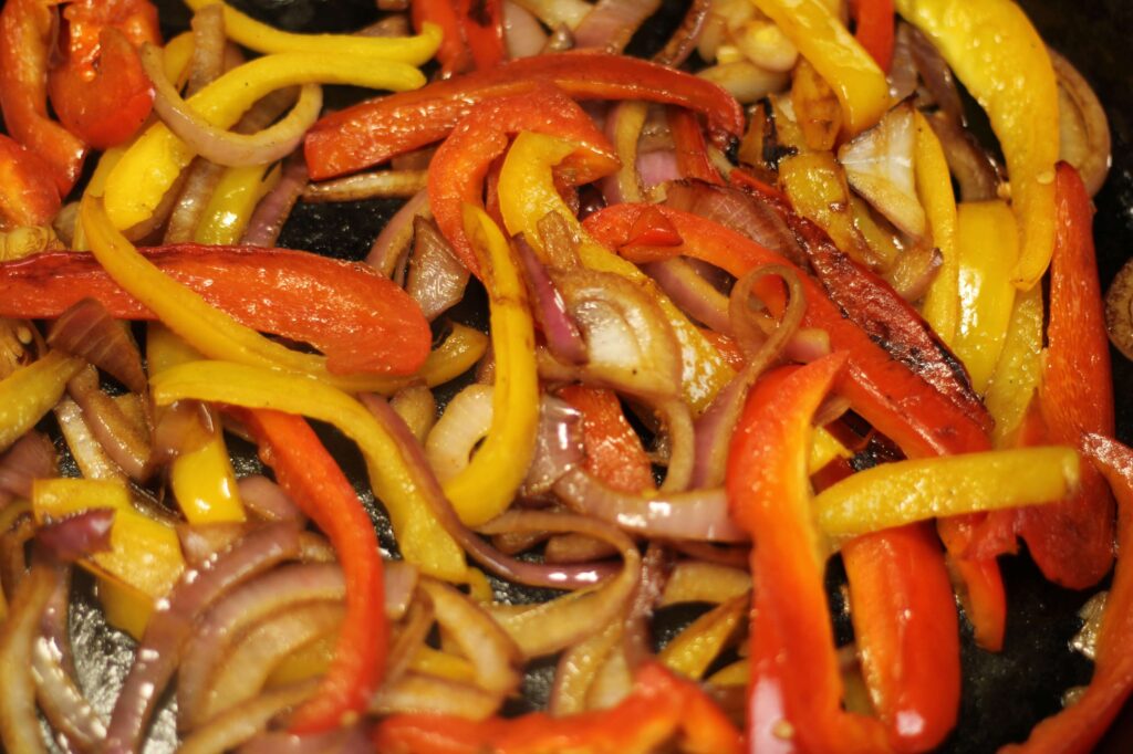 sautéed peppers and onions on cast iron skillet