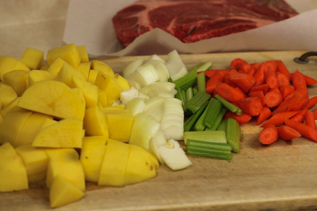 raw cut up potatoes, onions, celery, and carrots