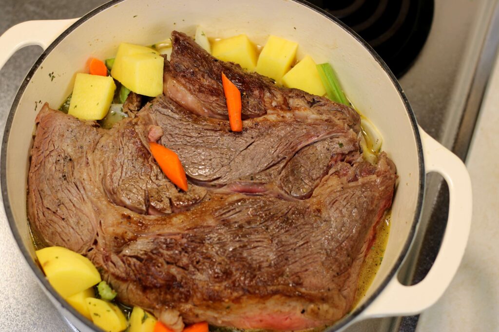 roast and vegetables in dutch oven before being roasted