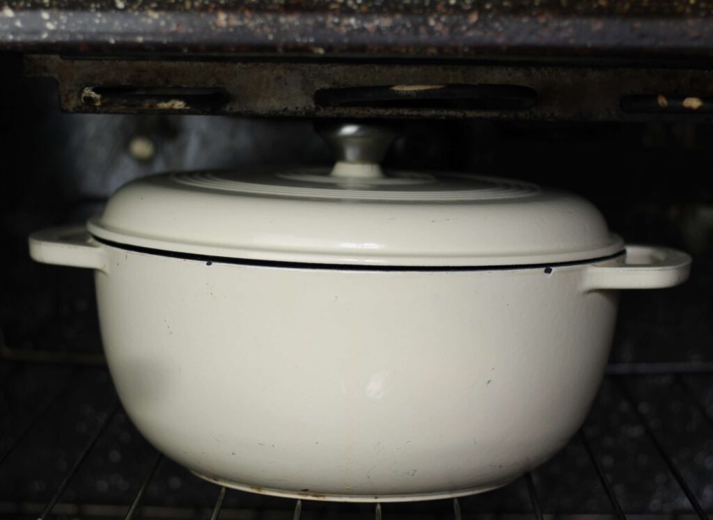 white dutch oven with lid in oven