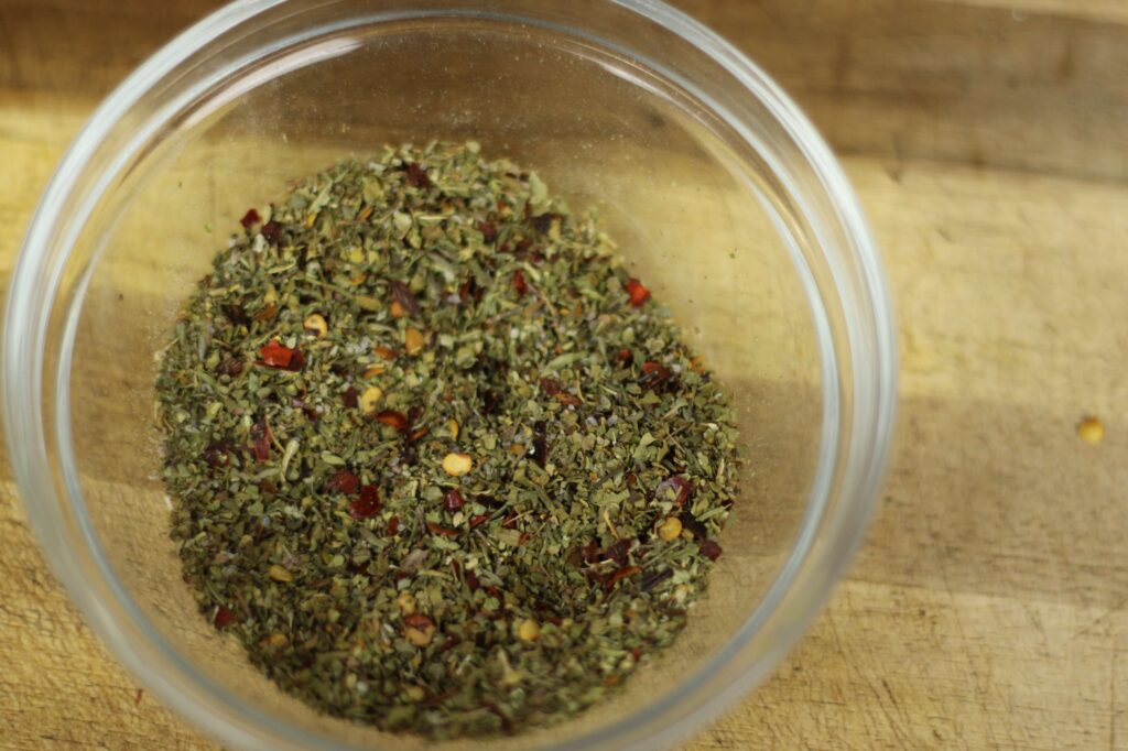 dried italian herbs and spices on glass bowl