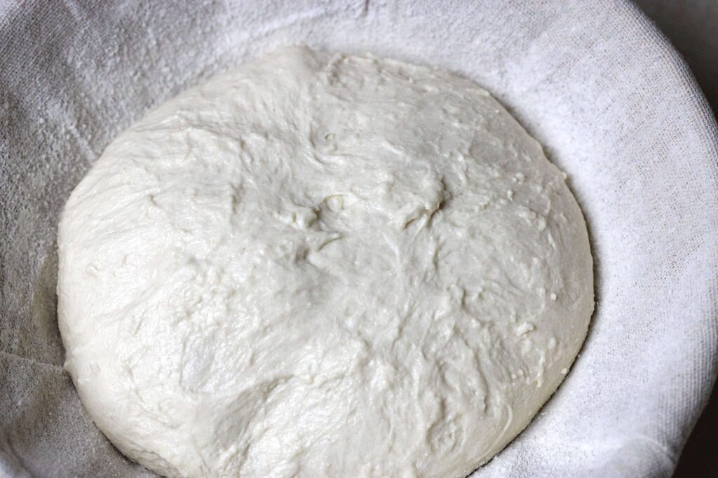 sourdough boule dough in bread basket