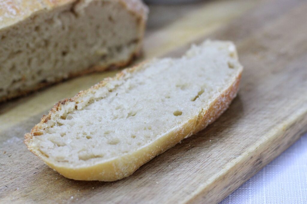 sourdough bread slice on wooden cutting board