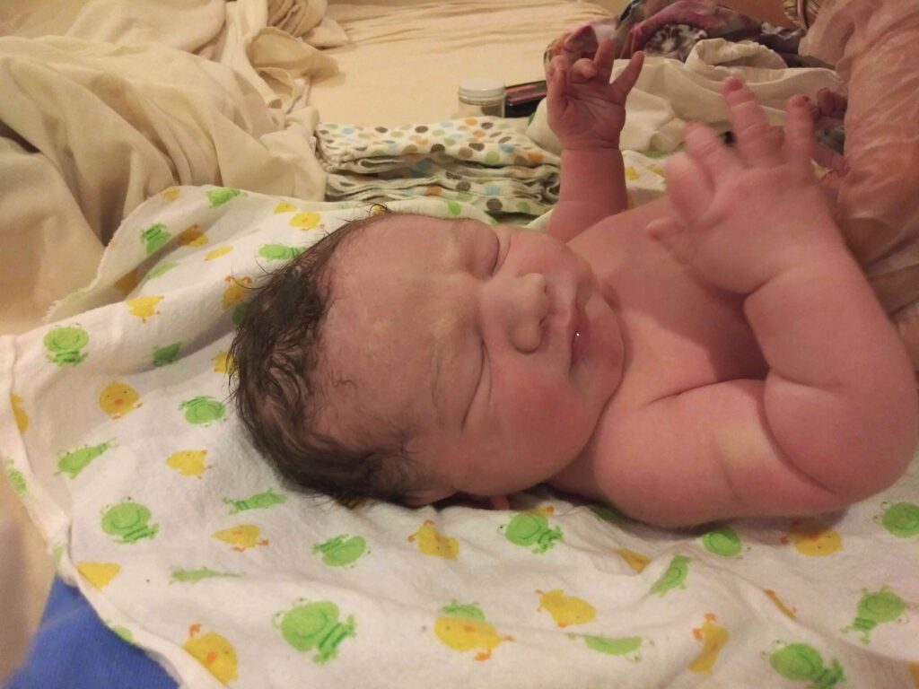newborn baby in bed 