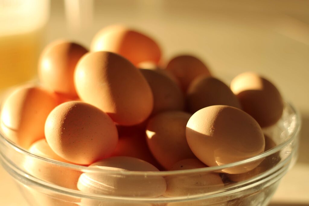 farm fresh brown eggs in glass bowl