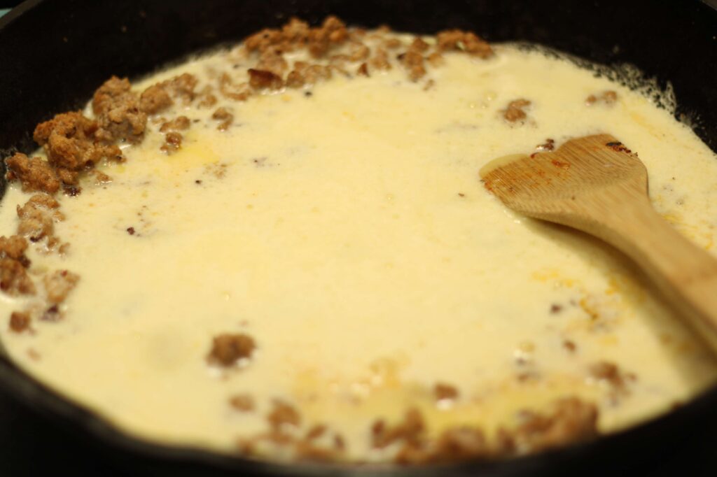scrambled eggs added to cast iron skillet 
