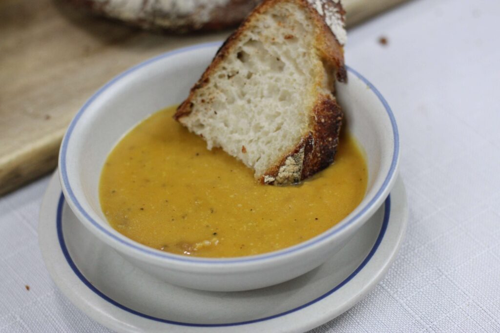 wholesome butternut squash soup and bread close up
