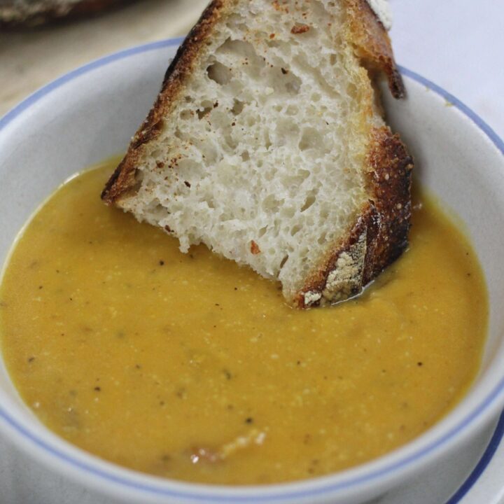 wholesome butternut squash soup in bowl with bread