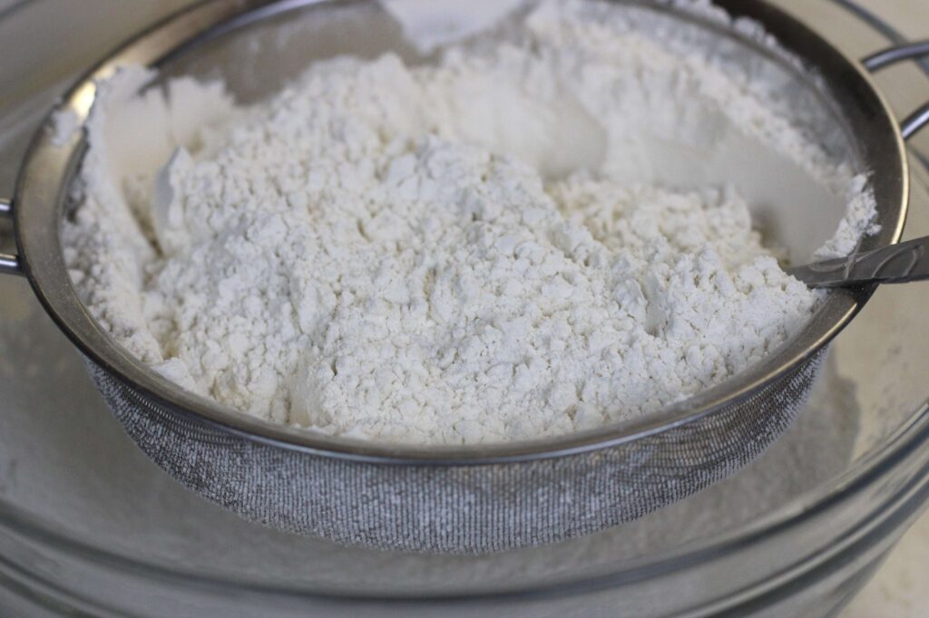 all-purpose flour in sifter and glass bowl