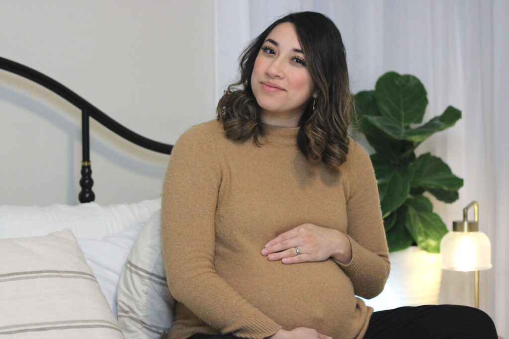 pregnant women sitting in bed 