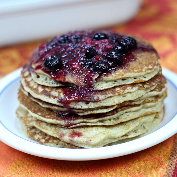 Stack of sourdough pancakes with berry syrup