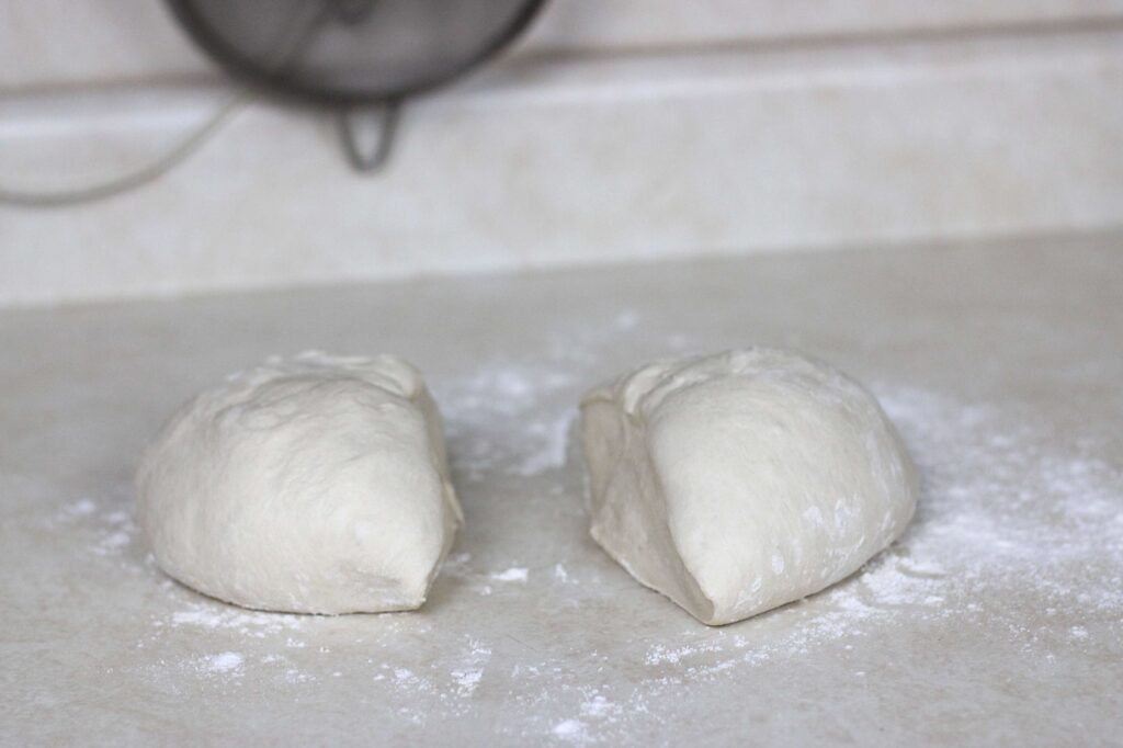 pastry dough on flour surface divided in two 