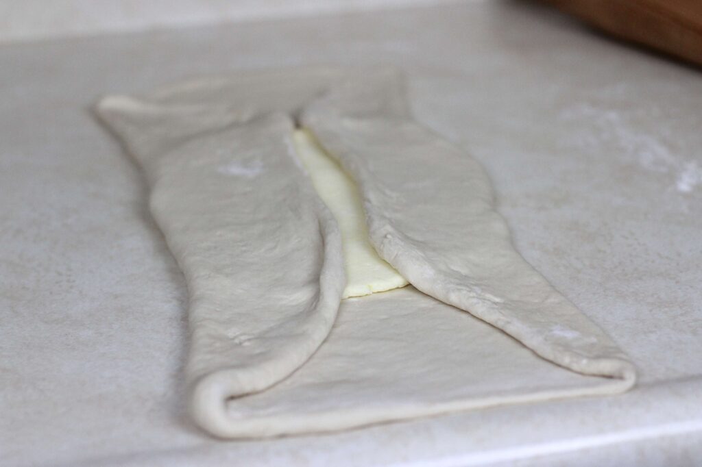 pastry dough folded over flattened butter for lamination