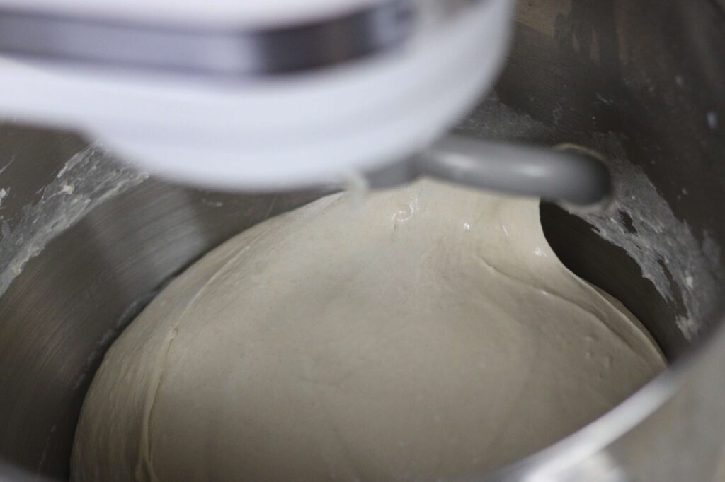 close up of finished bread dough inside stand mixer bowl