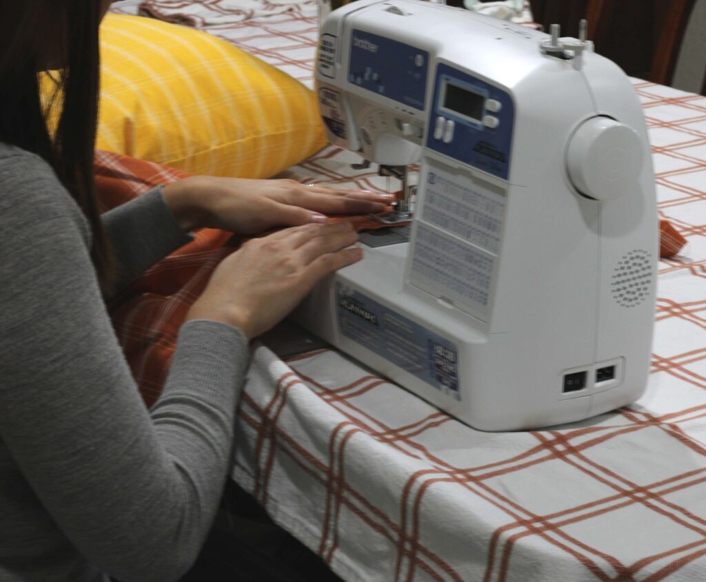 women sewing using a sewing machine 