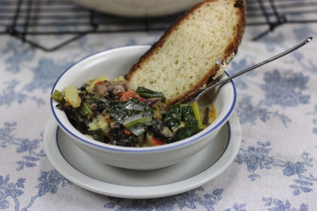 Bowl of homemade zuppa toscana and sourdough bread 