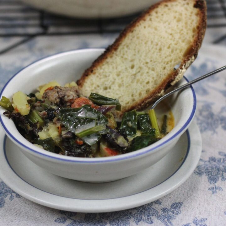 Bowl of homemade zuppa toscana and sourdough bread