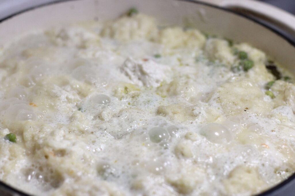 dumplings cooking in broth 