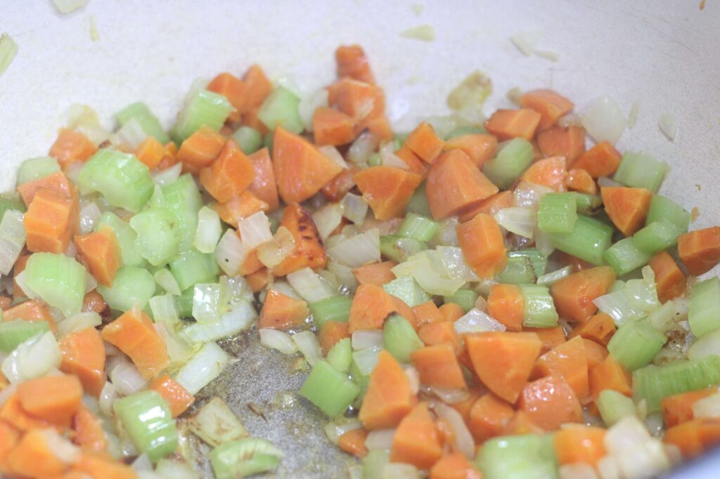 carrots, celery, and onions sauteing in dutch oven 