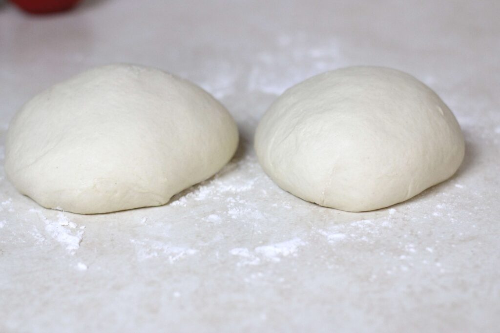 sourdough pizza dough divided into two