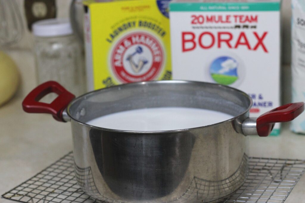 stainless steel pot with borax, washing soda, epsom salt and water cooling on cooling rack