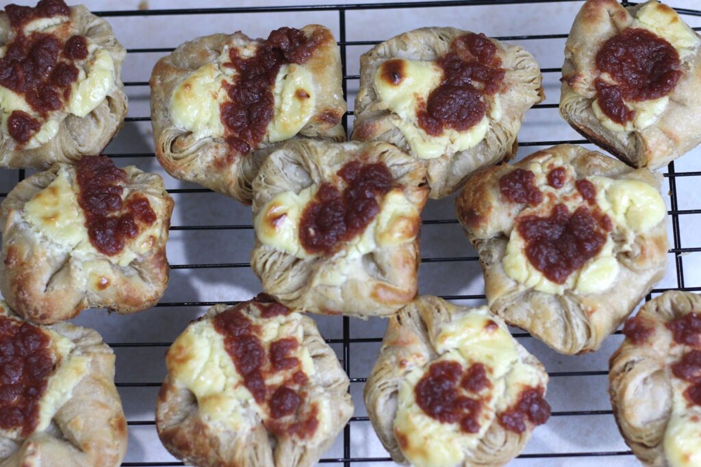 Freshly baked Spiced Apple Sourdough Danish in a cooling rack
