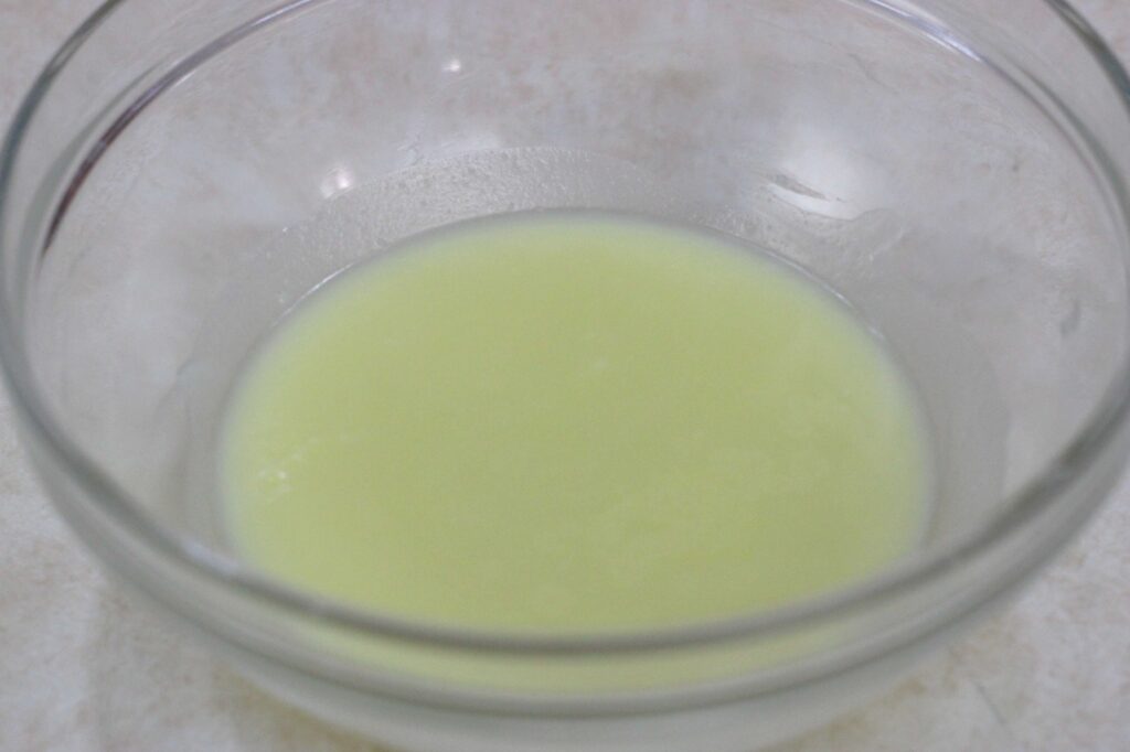 cooled tallow, olive oil, and essential oil mix for homemade tallow balm 