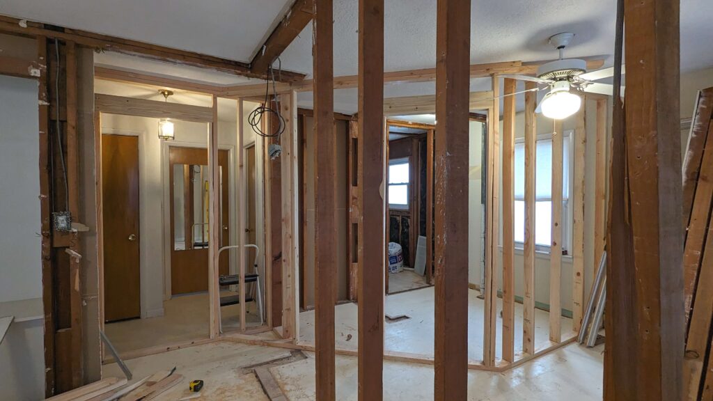 progress picture of house remodel making a master suite out of two smaller bedrooms studs and partial framing