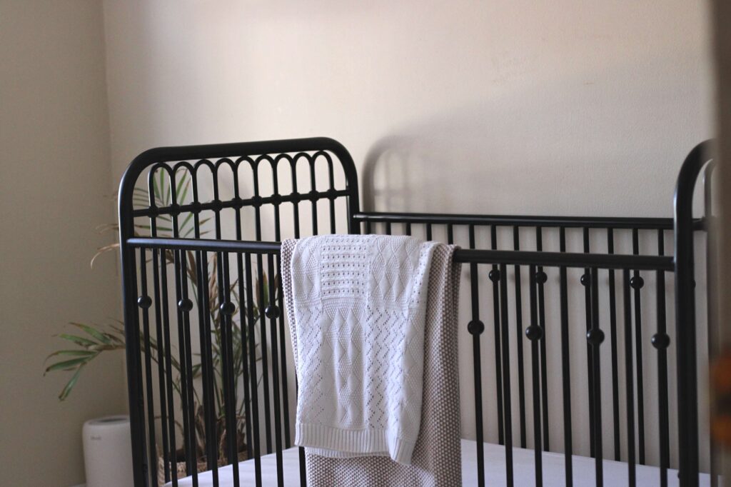 black iron crib in nursery 