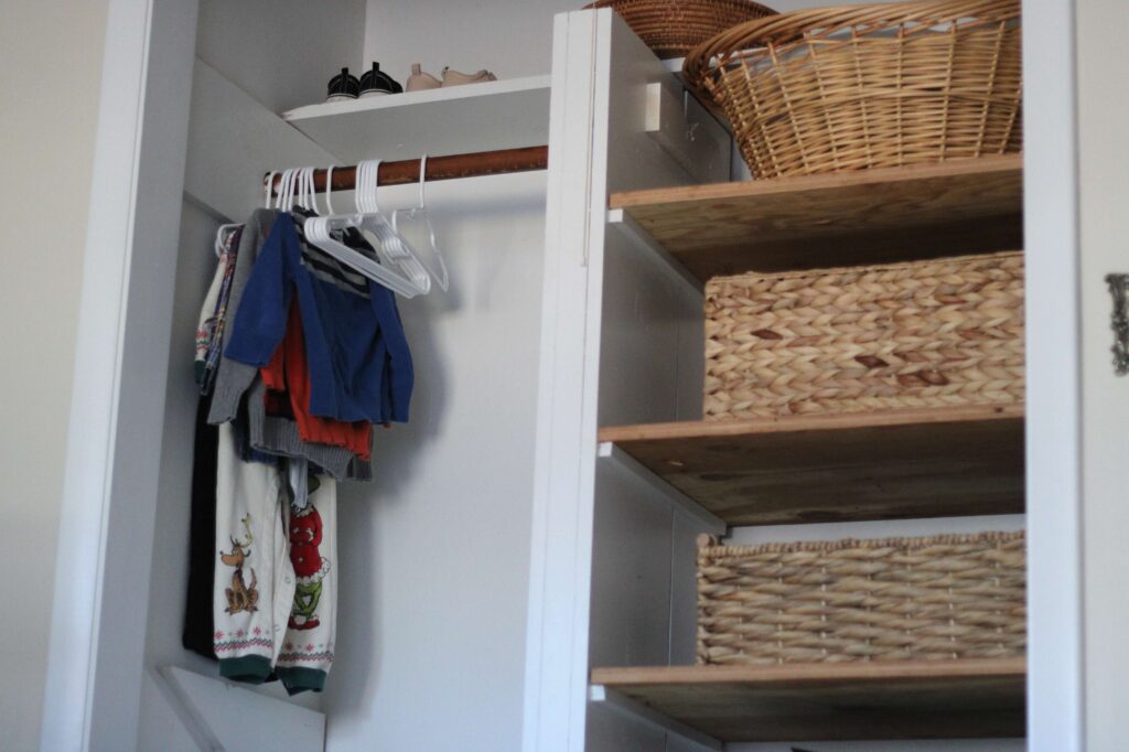 small nursery closet with basket organization prior to bedroom remodel 