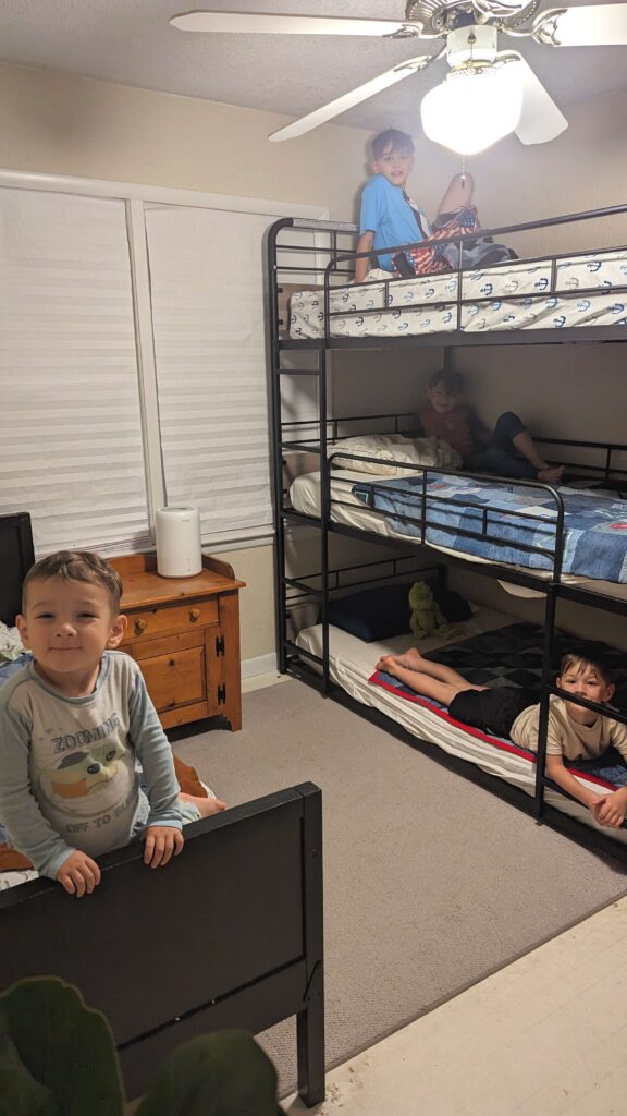 little boys room with triple bunkbeds and twin sized bed 