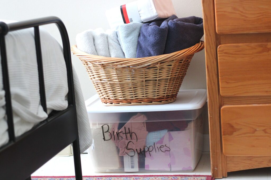 birth supplies organized on a tote, basket full of towels