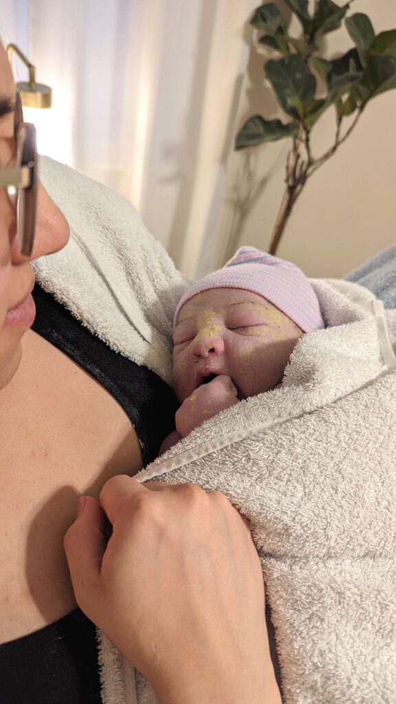 woman holding newborn baby a few hours after birth 