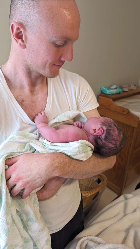 father holding newborn after homebirth