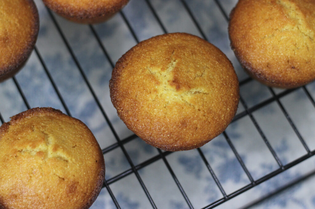 cornbread muffins cooling in black cooling rack