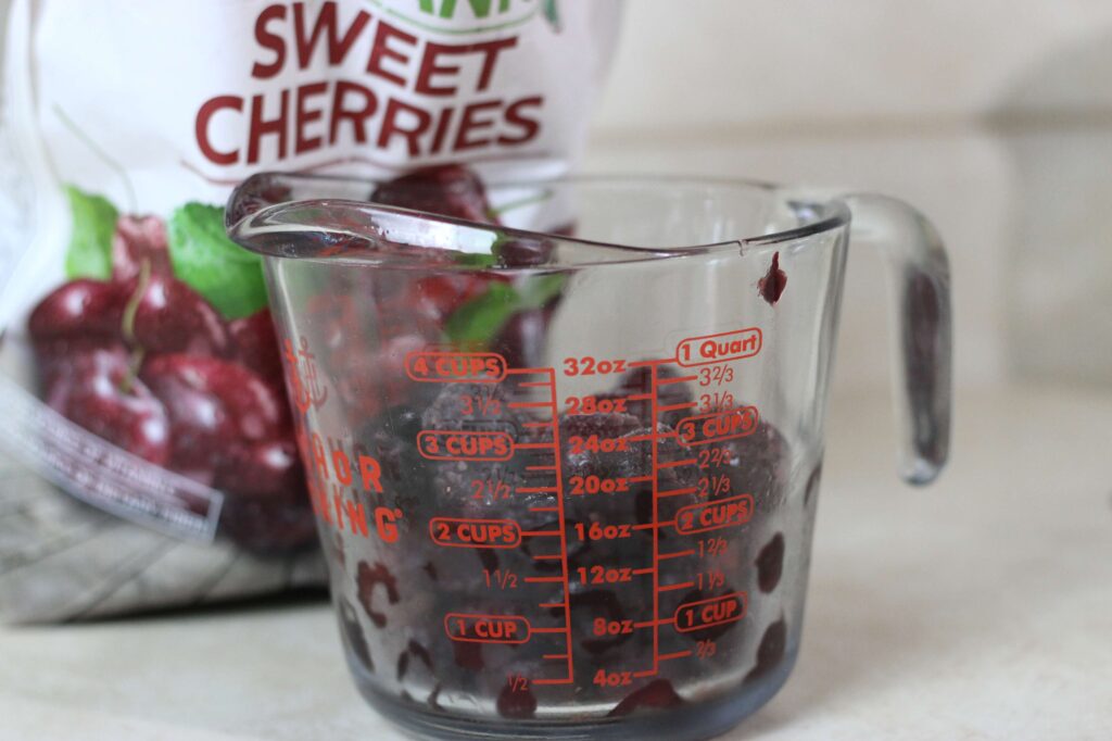 frozen cherries in measuring cup