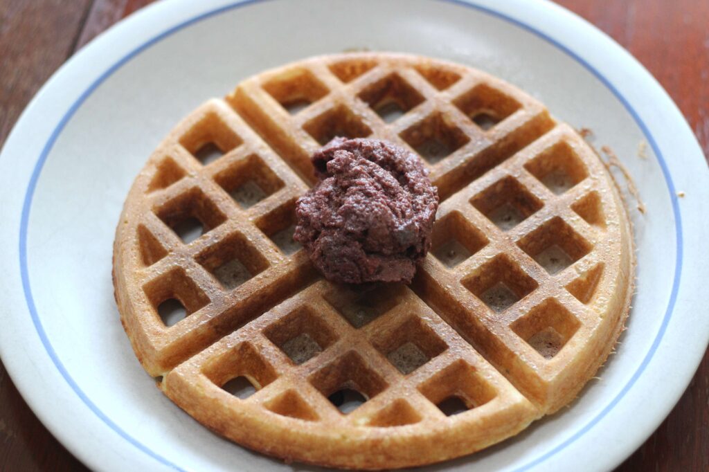 sourdough discard waffle on plate with cherry topping