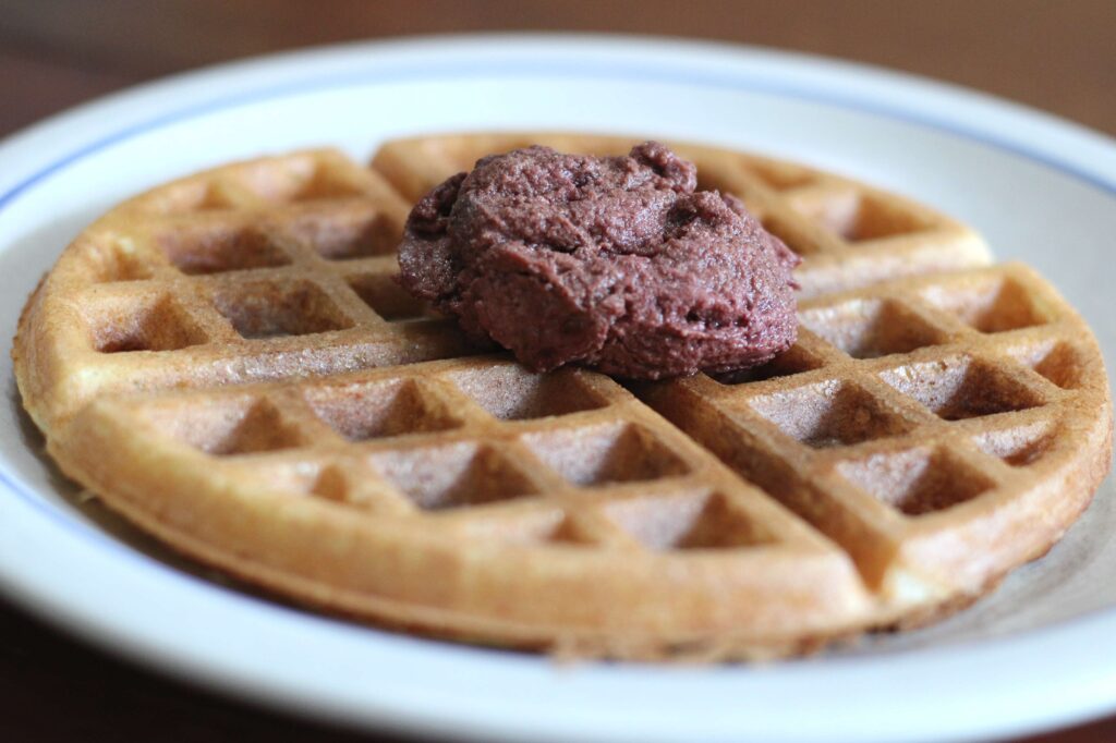 sourdough discard waffle in plate with cherry topping