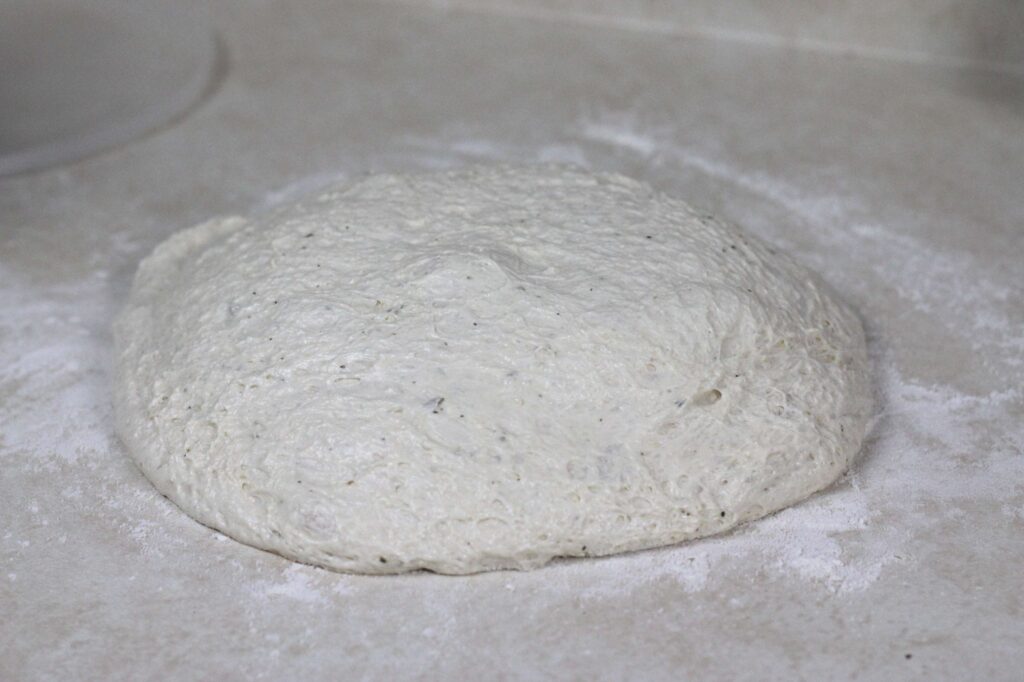 flatbread pizza dough on floured surfaced 