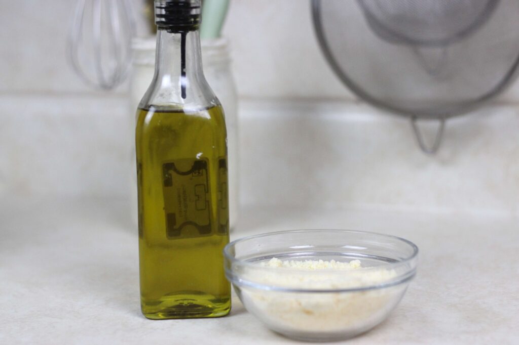 extra virgin olive oil and small glass bowl of grated parmesan cheese
