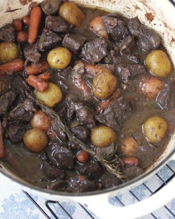 dutch oven with french beef stew, meat, potatoes, carrots