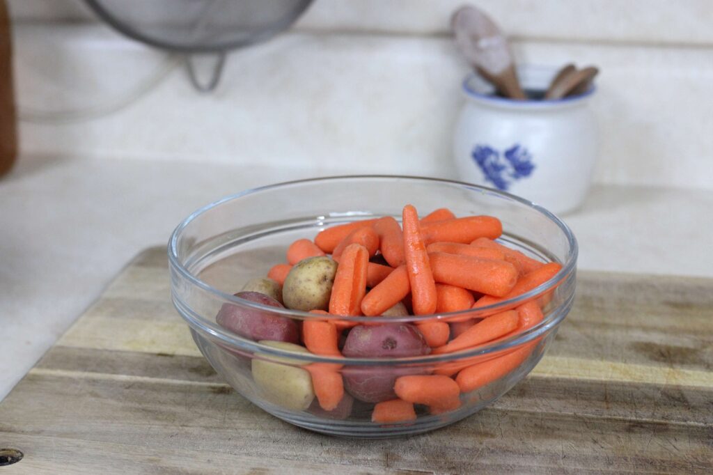 glass bowl of petite potatoes and baby carrots