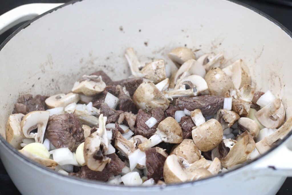 process shot of boeuf bourguignon in a pot