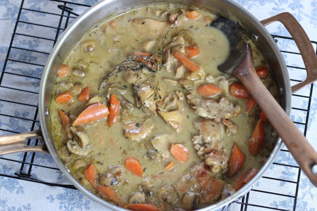 chicken fricasse in stainless steel skillet