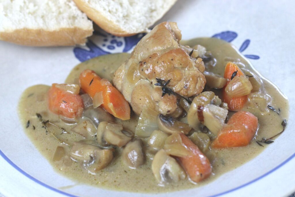 chicken fricassee served on a plate with bread
