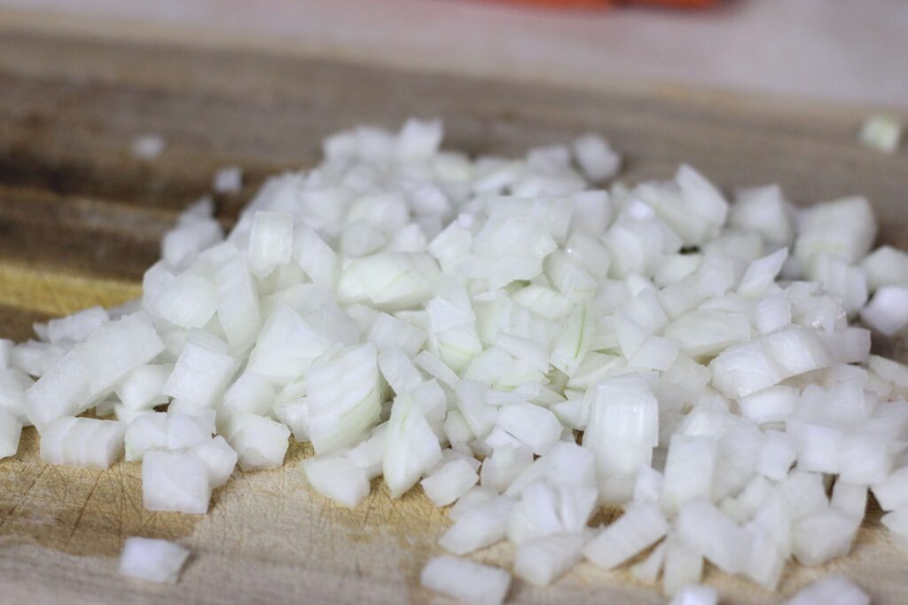 diced onion on wooden cutting board
